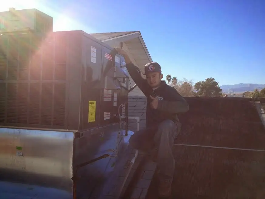 HVAC technician performing Air Duct Repair on a rooftop unit in Hastings-on-Hudson
