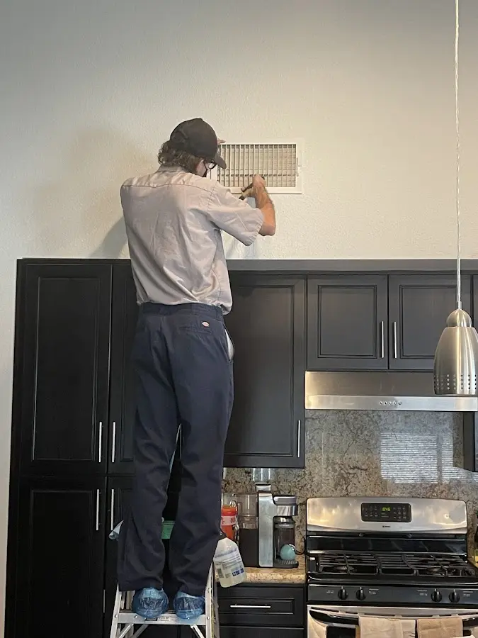 Technician inspecting an air vent during HVAC service in Hastings-on-Hudson